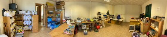 A panoramic image of a room which has been converted to a makeshift petrology lap. Within this room is a collection of equipment used to collect and analysis samples, as well as a library of lava samples from the La Palma eruption.