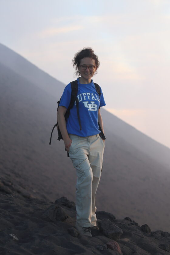 Teresa stood on a slope in the field at Stromboli volcano, smiling at the camera.