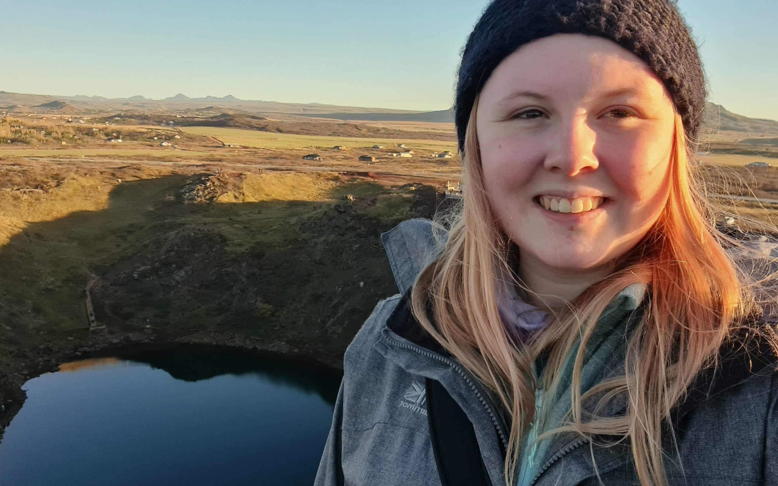 A photo of Jade with green countryside in the background.